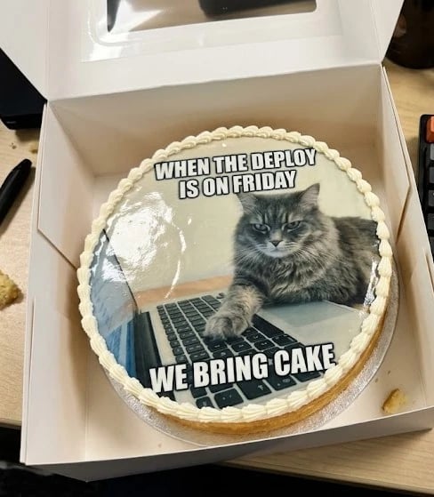 Cake printed with a cat-at-the-laptop meme