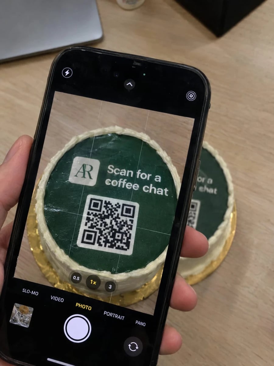 A phone scanning the QR code on a cake